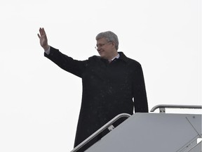 Prime Minister Stephen Harper boards a plane heading to Poland in Ottawa, Tuesday June 3, 2014 .