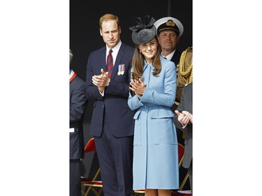 Prince William, Duke of Cambridge and Kate the Duchess of Cambridge applaud during a remembrance ceremony in Arromanches, western France, Friday, June 6, 2014, as part of the commemoration of the 70th anniversary of the D-Day landing.