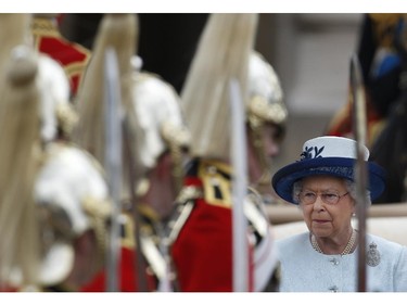 Queen Elizabeth II reviews mounted parading troops during the Trooping The Colour parade, outside Buckingham Palace in central London, Saturday, June 14, 2014. Hundreds of soldiers in ceremonial dress have marched in London in the annual "Trooping the Colour" parade to mark the official birthday of Queen Elizabeth II. "Trooping the Colour" originated from traditional preparations for battle, when flags were carried or "trooped" down the rank for soldiers to see.