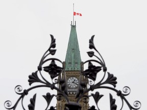 The Canadian flag flies at half-mast on the Peace Tower in Ottawa on Thursday June 5, 2014, after three police officers were killed and two injured by a gunman in Moncton, N.B. A letter writer shares his experience, visiting the police memorial, on Parliament Hill.