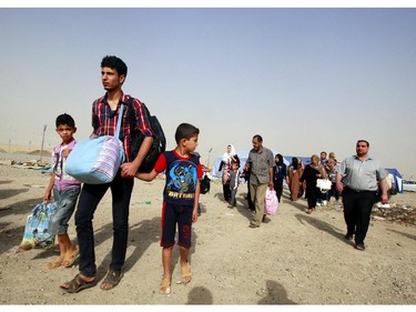 Refugees fleeing from Mosul head to the self-ruled northern Kurdish region in Irbil, Iraq, 350 kilometers (217 miles) north of Baghdad, Thursday, June 12, 2014. The Islamic State of Iraq and the Levant, the al-Qaida breakaway group, on Monday and Tuesday took over much of Mosul in Iraq and then swept into the city of Tikrit further south. An estimated half a million residents fled Mosul, the economically important city.