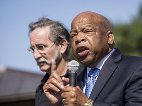 From L, David Goodman, brother of the late civil rights activist Andrew Goodman and president of the Andrew Goodman Foundation, looks on as Rep. John Lewis (D-GA) speaks during a news conference in support of the Voting Rights Amendment Act, on Capitol Hill, June 24, 2014 in Washington, DC.