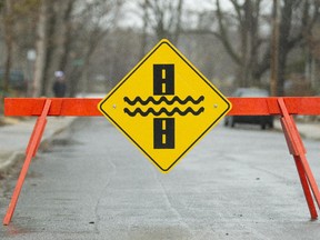 Road sign warning of flooded road on Belmont Avenue in Ottawa South on April 15, 2014.