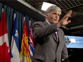 Senator Romeo Dallaire waves as he leaves the podium after announcing he will retire from the Senate during a news conference on Parliament Hill in Ottawa on Wednesday, May 28, 2014.