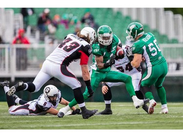 REGINA, SK - JUNE 14: Marshay Green #1 of the Saskatchewan Roughriders evades Travis Brown #43 of the Ottawa RedBlacks for a big punt return in the first half during in a game between the Ottawa RedBlacks and Saskatchewan Roughriders at Mosaic Stadium on June 14, 2014 in Regina, Saskatchewan, Canada.