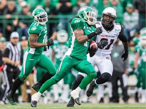 Marshay Green #1 of the Saskatchewan Roughriders outruns Jasper Simmons #31 of the Ottawa RedBlacks in the first half during a game between the Ottawa RedBlacks and Saskatchewan Roughriders at Mosaic Stadium on June 14, 2014 in Regina, Saskatchewan, Canada.