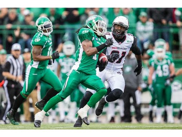 REGINA, SK - JUNE 14: Marshay Green #1 of the Saskatchewan Roughriders outruns Jasper Simmons #31 of the Ottawa RedBlacks in the first half during a game between the Ottawa RedBlacks and Saskatchewan Roughriders at Mosaic Stadium on June 14, 2014 in Regina, Saskatchewan, Canada.
