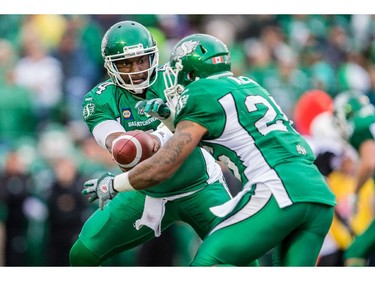 REGINA, SK - JUNE 14: Darian Durant #4 of the Saskatchewan Roughriders hands off to Anthony Allen #26 of the Saskatchewan Roughriders during pre-season week B of the 2014 CFL season in a game between the Ottawa RedBlacks and Saskatchewan Roughriders at Mosaic Stadium on June 14, 2014 in Regina, Saskatchewan, Canada.