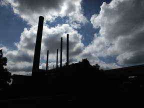The afternoon sun silhouettes the smoke stacks on the Heinz plant in Leamington on Thursday, June 26, 2014. After over a century of business in the town the factory will close this Friday.