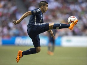 Vancouver Whitecaps' Sebastian Fernandez leaps to knock the ball out of the air and gain control against the Montreal Impact during second half MLS soccer action in Vancouver, B.C., on Wednesday June 25, 2014.