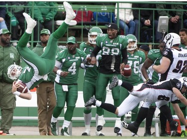 The Saskatchewan Roughriders bench reacts as their quarterback Seth Doege flips though the air after taking a hit from Ottawa Redblacks defensive back Antoine Pruneau during the second half of CFL pre-season football action in Regina, Sask., Saturday, June 14, 2014. The Riders defeat the Redblacks 21-17.THE CANADIAN PRESS/Liam Richards