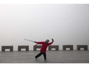 JILIN, CHINA - JUNE 12:  (CHINA OUT) A woman does morning excercises near the Songhua River on June 12, 2014 in Jilin, Jilin province of China. Heavy fog hit China's northeast city Jilin with the visibility of no more than 100 meters.