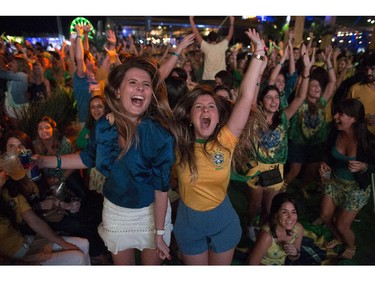 Soccer fans celebrate the second goal scored by Brazil striker Neymar, during a live broadcast at a World Cup viewing party at the Jockey Club, in Rio de Janeiro, Brazil, Thursday, June 12, 2014. After taking the early lead in the opening match of the international soccer tournament, Croatia fell 3-1 to the five-time champion Brazil.