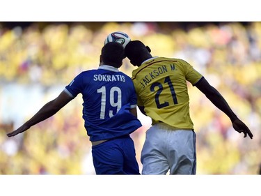Greece's Sokratis Papastathopoulos, left,  heads the ball against Colombia's Jackson Martinez during the group C World Cup soccer match between Colombia and Greece at the Mineirao Stadium in Belo Horizonte, Brazil, Saturday, June 14, 2014.  Colombia won 3-0.