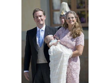 Princess Madeleine of Sweden (R) and her husband Christopher O'Neill hold their daughter, Princess Leonore on June 8, 2014 after her christening at the Royal Chapel in Drottningholms royal palace near Stockholm.