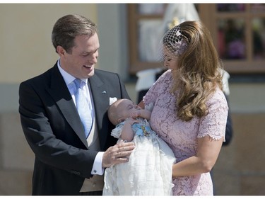 Princess Madeleine of Sweden (R) and her husband Christopher O'Neill hold their daughter, Princess Leonore on June 8, 2014 after her christening at the Royal Chapel in Drottningholms royal palace near Stockholm.