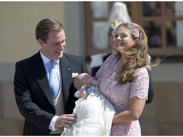 Princess Madeleine of Sweden (R) and her husband Christopher O'Neill hold their daughter, Princess Leonore on June 8, 2014 after her christening at the Royal Chapel in Drottningholms royal palace near Stockholm.