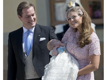 Princess Madeleine of Sweden (R) and her husband Christopher O'Neill hold their daughter, Princess Leonore on June 8, 2014 after her christening at the Royal Chapel in Drottningholms royal palace near Stockholm.