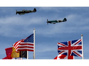 BAYEUX, FRANCE - JUNE 06:  The Battle of Britain Memorial flight passes flags at Arrowmanches-Les-Bains during D-Day 70 Commemorations on June 6, 2014 near Bayeux, France. Friday 6th June is the 70th anniversary of the D-Day landings which saw 156,000 troops from the allied countries including the United Kingdom and the United States join forces to launch an audacious attack on the beaches of Normandy, these assaults are credited with the eventual defeat of Nazi Germany. A series of events commemorating the 70th anniversary are planned for the week with many heads of state travelling to the famous beaches to pay their respects to those who lost their lives