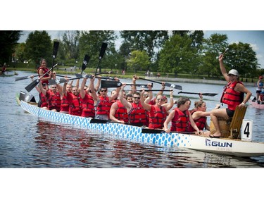 The Destroyers celebrate a win after the 500m mixed finals Sunday at The 21st Tim Hortons Ottawa Dragon Boat Festival which took place this past weekend at Mooney's Bay Park. (Ashley Fraser / Ottawa Citizen)