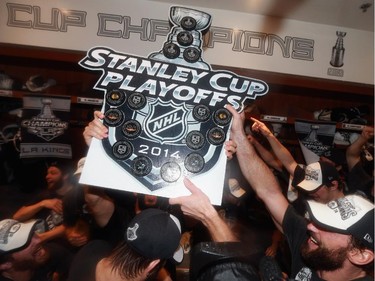 The Los Angeles Kings celebrate in the locker room after the team won the Stanley Cup in double overtime over the New York Rangers in Game 5 of the 2014 Stanley Cup Final series Friday, June 13, 2014, in Los Angeles, California. The Kings won the game 3-2.