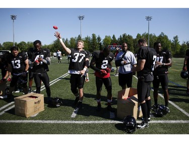 The Ottawa RedBlacks signed toy footballs and threw them to the fans after an intrasquad game at the Mont-Bleu Sports Complex in Gatineau on Saturday, June 7, 2014.