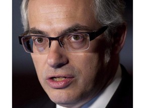 Treasury Board President Tony Clement speaks with the media on March 26, 2014 in Ottawa.