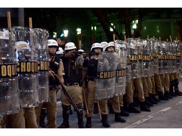 TOPSHOTS  Riot police stand opposite demonstrators during a protest against the 2014 FIFA World Cup in Belo Holizonte on June 12, 2014.