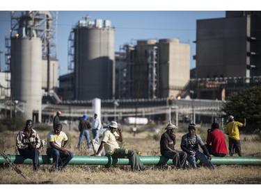 TOPSHOTS Striking platinum miners gather at the Wonderkop Stadium in Marikana waiting to receive news on an ending strike proposed deal on June 12, 2014 in Marikana, South Africa. The world's biggest platinum producers said on Thursday they had reached "in principle undertakings" with South African union leaders which could end the crippling strike. Union leaders would now seek a mandate from their members to accept offers on pay and conditions and if they succeed "it will bring to an end the 21-week long strike," Anglo American Platinum, Impala Platinum and Lonmin said in a statement. Leaders of the Association of Mineworkers and Construction Union (AMCU) were meeting with union members Thursday, and the companies said they expected a response on Friday.