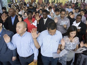 Some of the 142 new Canadian citizens taking the citizenship oath on Canada Day in 2009 in Downsview Park in Toronto.