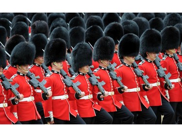 Members of the Foot Guards march past Queen Elizabeth II, military dignitary and members of the public during Trooping the Colour at The Royal Horseguards on June 14, 2014 in London, England.
