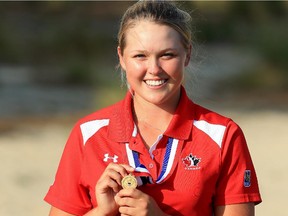 Brooke Henderson holds the Low Amateur medal she won at the U.S. Women's Open.