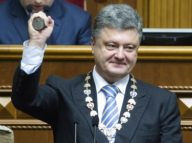 This handout picture taken and released by the Presidential press service on June 7, 2014 displays Ukraine's President Petro Poroshenko holding the Presidential stemp during a ceremony of his oath in the Parliament in Kiev. Poroshenko, a 48-year-old billionaire, was sworn in as Ukraine's fifth post-Soviet president Saturday, vowing to maintain the unity of his country amid a continuing crisis with Russia. Poroshenko won the presidential election on May 25 with 54.7 percent of the vote.