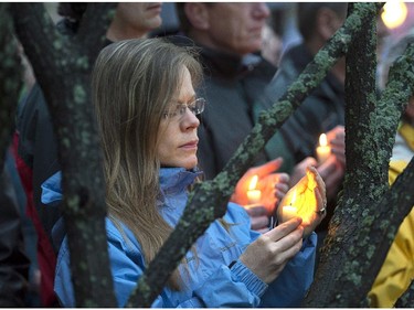 A large crowd participates in a candle light vigil in Moncton, N.B. on Friday, June 6, 2014 to pay respect to the three RCMP officers who were killed and the two injured in a shooting spree on Wednesday. Justin Bourque, 24, is facing three charges of first-degree murder and two charges of attempted murder.