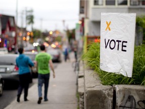 Votes leave the Dalhousie Community Centre polling station in Ottawa, June 12, 2014. (Chris Roussakis/ Ottawa Citizen)