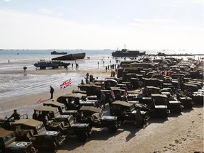 World War II military vehicles are displayed on the beach of Arromanches, France,  Friday, June 6, 2014, as part of D-Day commemorations. World leaders and veterans gathered by the beaches of Normandy on Friday to mark the 70th anniversary of World War Two's D-Day landings.