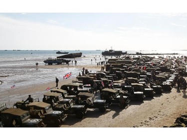 World War II military vehicles are displayed on the beach of Arromanches, France,  Friday, June 6, 2014, as part of D-Day commemorations. World leaders and veterans gathered by the beaches of Normandy on Friday to mark the 70th anniversary of World War Two's D-Day landings.