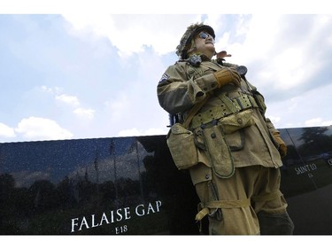 World War II re-enactor, John Werner, of Chatham, Ill., participates in ceremonies to mark the 70th anniversary of the World War II D-Day invasion at Normandy, France, in front of the World War II Memorial at Oak Ridge Cemetery Friday, June 6, 2014, in Springfield, Ill.