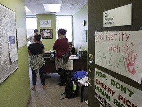 A small group of Ottawa Centre voters occupied NDP MP Paul Dewar's constituency office Thursday to protest what they characterized as the NDP's shifting policy on Israel and Palestinian claims in Gaza.