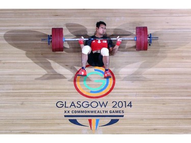 GLASGOW, SCOTLAND - JULY 27:  Abd Mubin Rahim of Malaysia falls to the floor after an unsuccessful lift during the Men's Weightlifting 77kg category at Scottish Exhibition And Conference Centre during day four of the Glasgow 2014 Commonwealth Games on July 27, 2014 in Glasgow, United Kingdom.