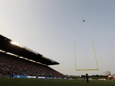 A Canadian Armed Forces CF-18 Hornet fighter soars across the sky during the Ottawa RedBlacks home opener at TD Place on Friday, July 18, 2014.