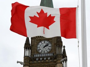 A Canadian flag blows in front of the Peace Tower on Parliament Hill in Ottawa, Ont., Wednesday, Oct. 24, 2012.