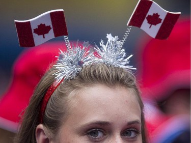 A fan wears novelty headware as the Toronto crowd celebrates Canada Day during interleague baseball action between Toronto Blue Jays and Milwaukee Brewers in Toronto on Tuesday July 1 , 2014.