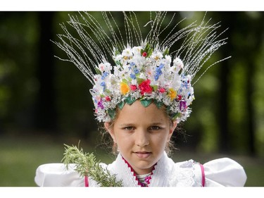 A girl poses in a traditional dress in the style of the village of Rimoc, during a Paloc festival honoring St. Anna in Balassagyarmat, 80 kms north of Budapest, Hungary, Sunday, July 27, 2014. The Paloc are a group of Hungarian ethnicity with their own traditions, folk art and dialect living in a region in northern Hungary.