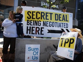 Activists protest outside the Ottawa Delta Hotel in July 2014, where the government was hosting closed-door talks on the Trans-Pacific Partnership.