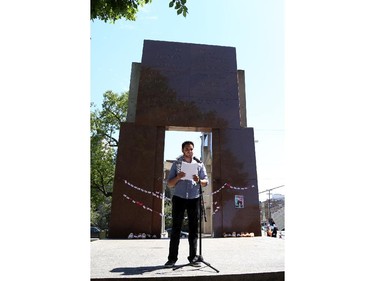 A man speaks at the podium as hundreds gathered in support of Palestine at the Human Rights Memorial in Ottawa, Saturday, July 12, 2014. Many brought banners and flags, and chanted, and later, they marched toward another rally in front of the US embassy on Sussex Dr.