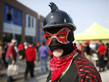 A man who called himself el rojo negro dons a luchador mask and a mohawk helmet for the Redblacks' home opener at TD Place on Friday, July 18, 2014.