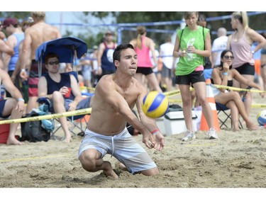 A player digs the ball as he takes part in the HOPE Volleyball Summerfest at Mooney's Bay Beach in Ottawa on Saturday, July 12, 2014.