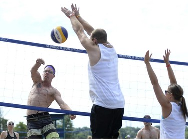 A player spikes the ball during the HOPE Volleyball Summerfest at Mooney's Bay Beach in Ottawa on Saturday, July 12, 2014.