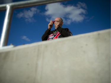 A Redblacks fan takes a photo in the stands at the official opening of TD Place at Lansdowne Wednesday July 9. 2014.